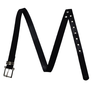 Detail of elegant black belt with silver eyelets and a polished metal buckle