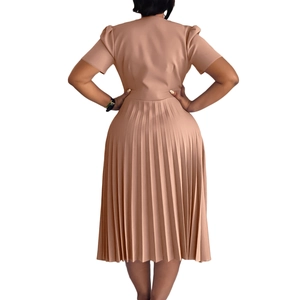Detail of elegant pleated hem and high-waist cut on a short-sleeved dusty pink dress