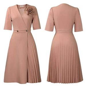 Detail view of pink V-neck pleated dress featuring waist buttons and floral accent