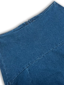 Detailed view of high-quality dark blue denim fabric with precise contrast stitching