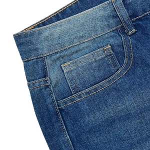 Detailed close-up of high waist denim jeans featuring orange stitching and classic coin pocket