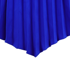 Detail of royal blue pleated hem with irregular pointed edges and fine overlock stitching