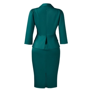 Detail view of dark green bodycon dress with elegant peplum waist and back slit hemline