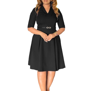 Detail of black V-neck dress featuring a turn-down collar and a gold ring buckle belt