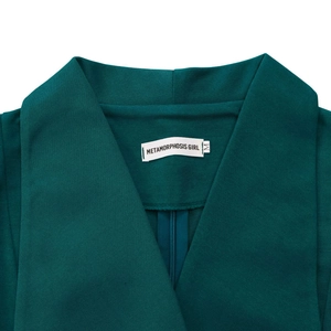 Close-up of elegant dark green dress collar with woven brand label and size M tag
