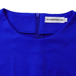 Detailed view of back invisible zipper and brand label on royal blue elegant dress