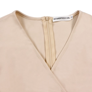 Detail of elegant V-neck and invisible zipper on this stylish beige wrap dress