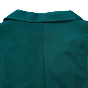 Close-up detail of dark green dress showing the collar structure and hidden back zipper