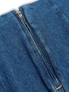 Detail shot of heavy-duty metal SBS zipper and double-stitched denim fabric texture
