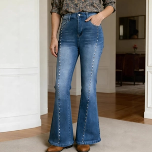Detail view of high waist flared jeans with metallic silver rivet studs on blue denim