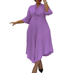 Detail of elegant purple pleated midi dress with pussy-bow neck and three-quarter sleeves