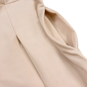 Detail of the nude beige fabric texture and side pocket on the elegant V-neck dress