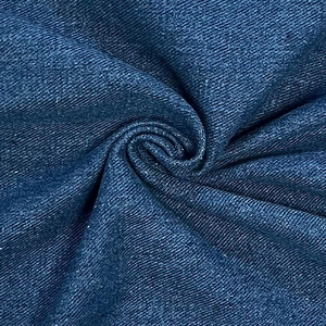 Macro detail of high-waist loose denim fabric with classic dark blue twill weave texture