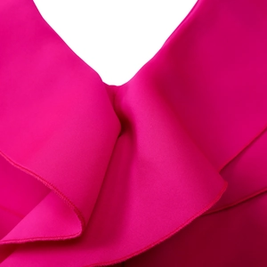 Close-up of rose red V-neck dress featuring layered ruffle details and textured fabric