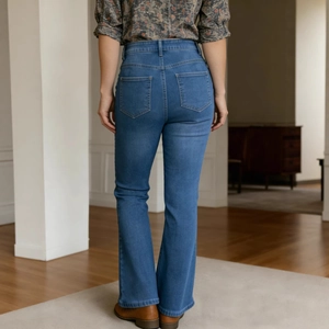 Detailed back view of high waist flare jeans with vintage rivets and washed blue finish