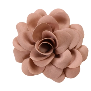 Detail of elegant pleated fabric petals on a dust pink 3D flower dress accessory