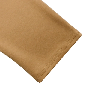Close-up of camel knit fabric showing double-needle stitching and ribbed texture