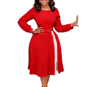 Detail of red long sleeve dress featuring cream side contrast panel and small hem slit