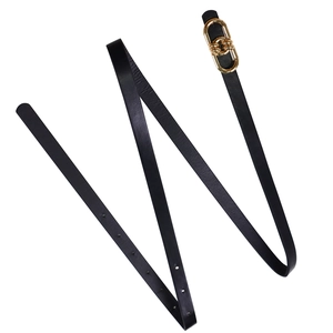 Detailed view of an elegant black leather waist belt with chic gold double ring buckle