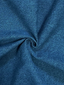 Macro texture of blue metallic denim fabric showing shiny pearlescent finish and drapes