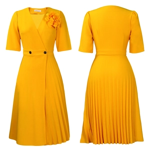 Detail view of yellow V-neck dress featuring floral applique and asymmetric pleated skirt