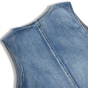 Close-up of light blue wash denim fabric texture with clean stitching details