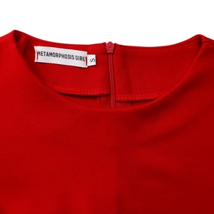 Close-up of elegant red dress neckline with stitched brand label and smooth zipper detail