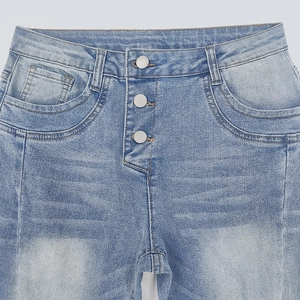 Detail view of high waist light blue jeans with a stylish three-button closure and washed finish