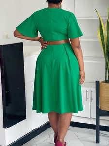 Elegant bright green V-neck dress with ruffle sleeves and slim belt, back view shot