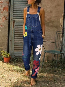 Detail of floral print denim overalls with daisy patterns and classic chest pocket