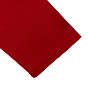 Detail view of red knitted fabric with high-quality double-needle stitching on the hemline