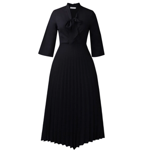 Detail of elegant black pleated dress showing pussy-bow neckline and fine accordion pleats