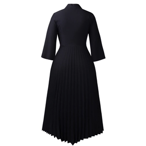 Detail of elegant black pleated hem and fitted waist on this three-quarter sleeve midi dress