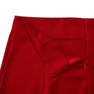 Close-up detail of high-waist red skirt with matching invisible zipper and premium fabric