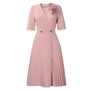 Detail of pink pleated midi dress with V-neck and handmade flower on the shoulder