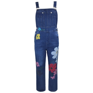 Detail of sunflower print on dark wash denim overalls with adjustable silver metal buckles