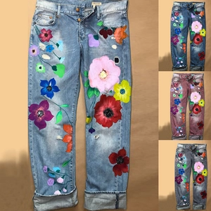 Women's straight-leg jeans with floral print, distressed details, and wide folded cuffs