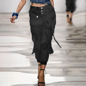 Detail of high waisted black denim wrap pants with tie-waist and multi-button closure