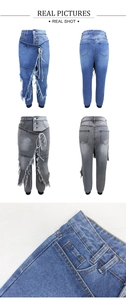 Detail of ripped frayed denim jeans with drawstring waist and asymmetrical button fly