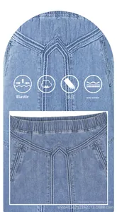 Détail de jupe en jean bleu clair avec taille haute élastique et coutures en V