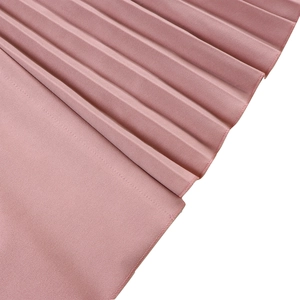Detail of pink pleated fabric with elegant stitching on a stylish V-neck dress