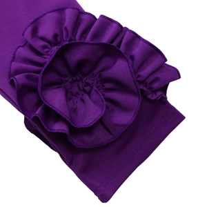 Detailed close-up of a deep purple knitted sleeve with a large 3D fabric flower design