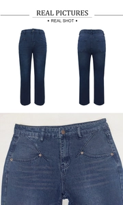 Detail of high waisted dark blue washed denim jeans with metal button and pocket stitching