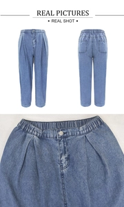 Détail de la taille haute élastique du jean avec plis et fermeture par bouton métallique