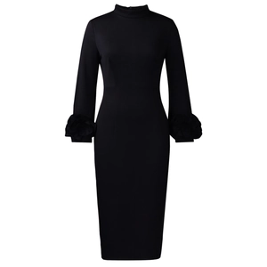 Detail of floral texture on cuffs of a slim fit black long sleeve dress with high neck