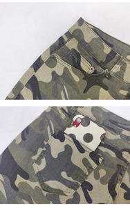 Detail view of camouflage denim shorts showing pocket rivets and stitching quality