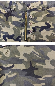 Detail of high waist camo shorts featuring metal zipper fly and branded jeans buttons