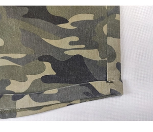 Detail shot of the camouflage print fabric and durable hem stitching on denim shorts