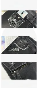 Detail of skull and wings embroidery with rhinestones on black denim jeans pockets