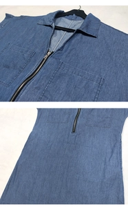 Detail view of blue denim dress showing the metal zipper, V-neckline and front square pockets